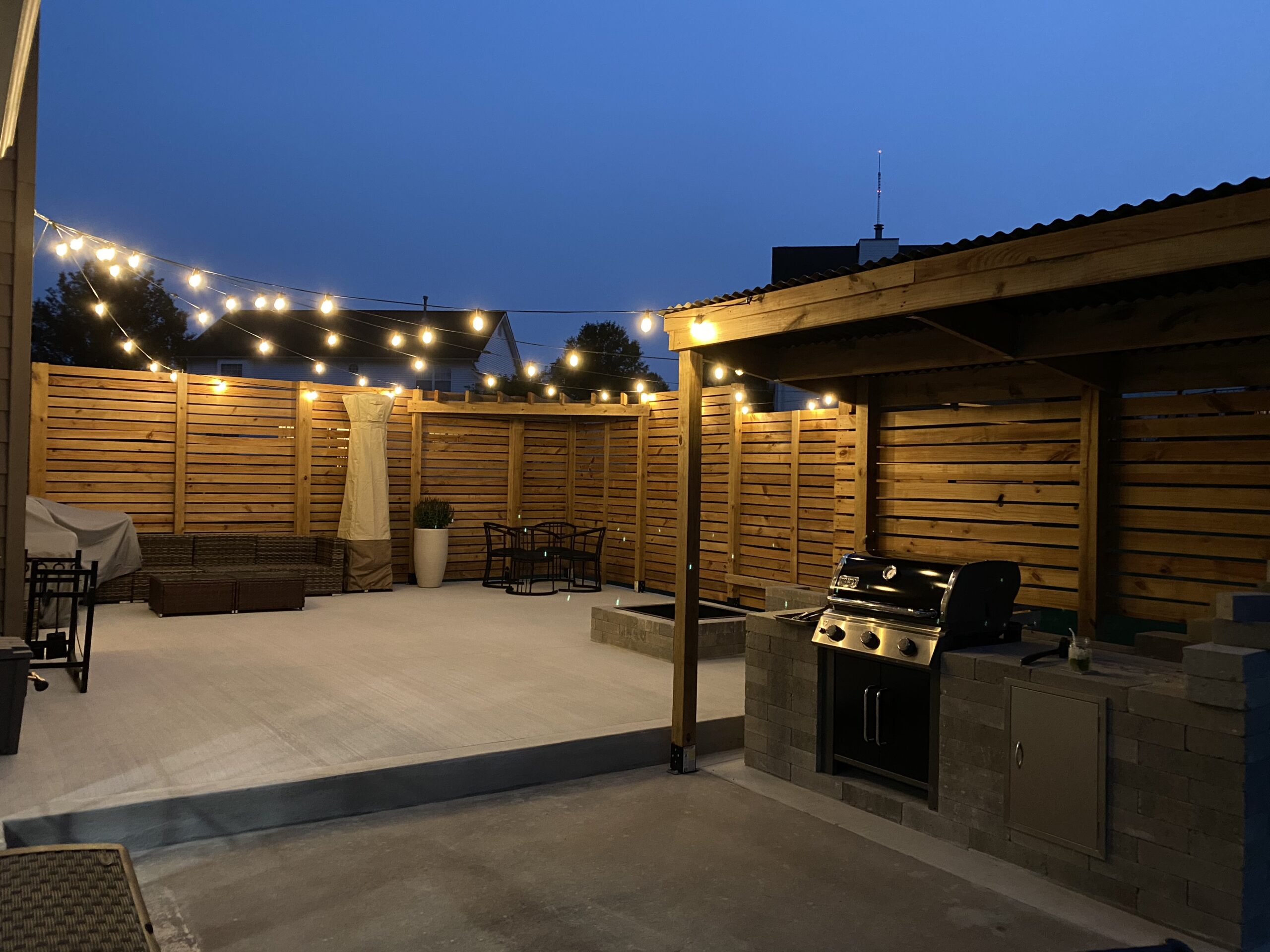 Furnished back patio with privacy fence, grill, and fire pit