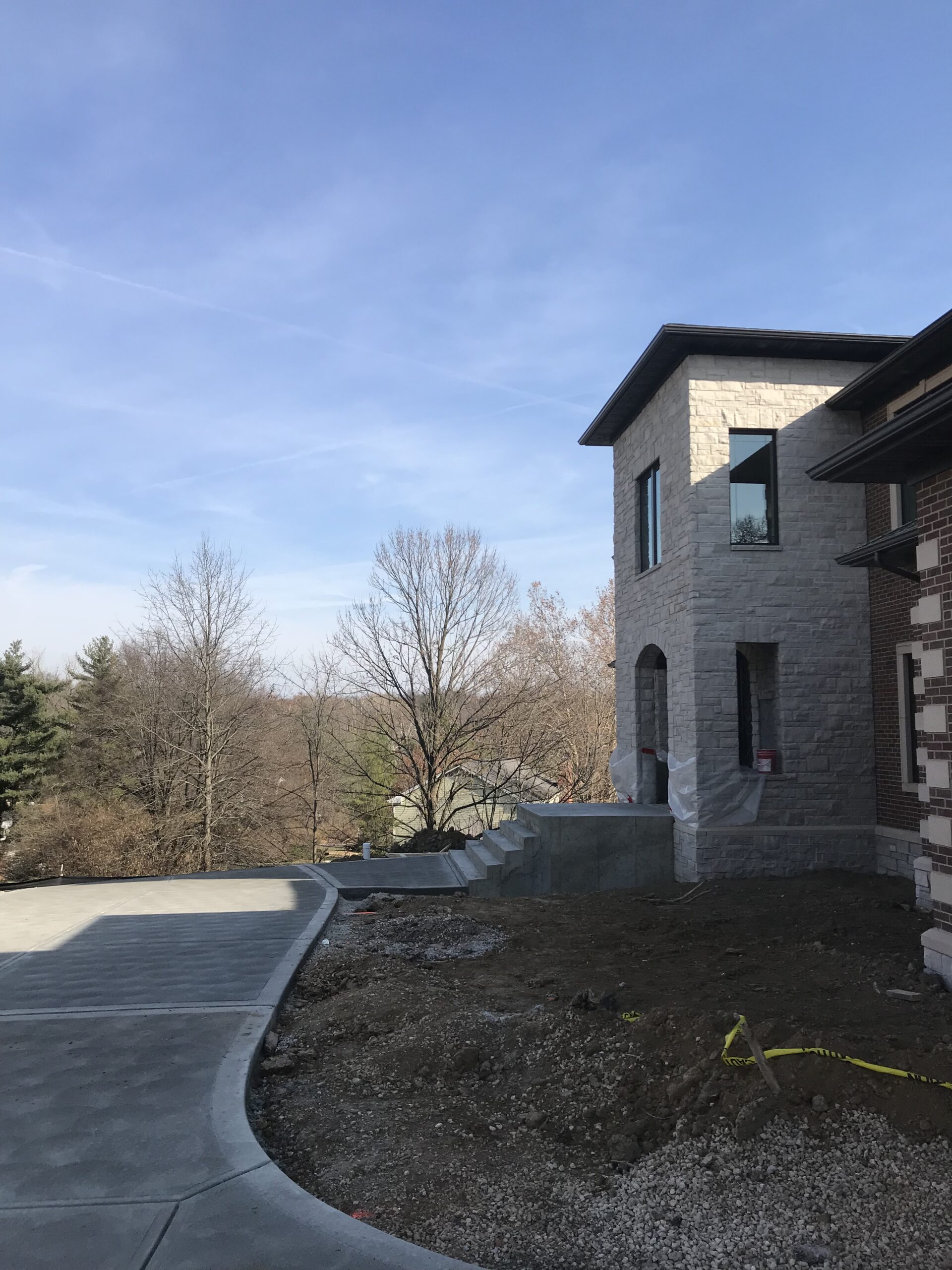 Side view of front of the house with stairs and driveway